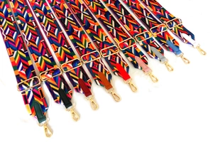 Détail de dix bandoulières tissées de style ethnique avec crochets dorés et embouts en cuir