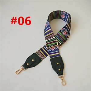 Detail of adjustable woven shoulder strap with geometric pattern and gold hardware