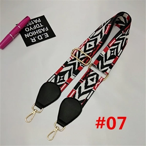Detail of wide nylon woven bag strap with red, white and black geometric pattern