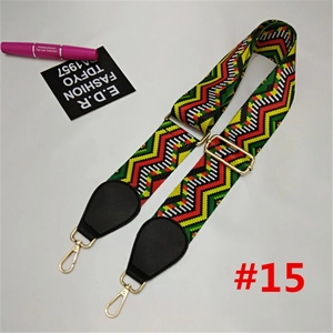 Detail of adjustable colorful woven nylon wide strap with gold hardware and leather ends