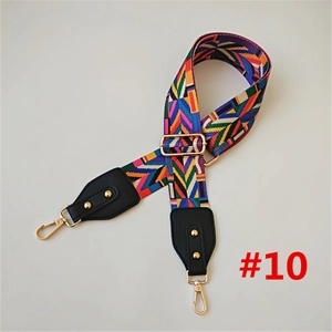 Detail view of colorful woven bag strap with geometric patterns and gold metal swivel hooks