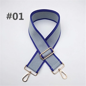 Detail of adjustable gray and blue nylon bag strap with polished gold lobster clasps