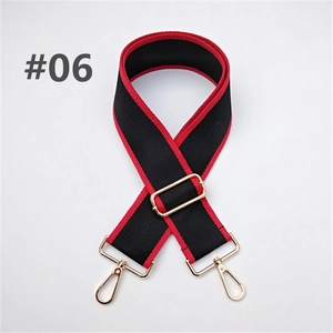 Detail of adjustable black and red woven bag strap with golden metal swivel hooks