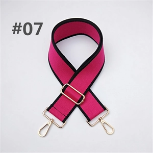 Detail of adjustable rose pink canvas bag strap with black trim and gold hardware