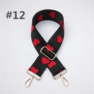 Detail of adjustable wide black strap with red heart patterns and gold metal hardware
