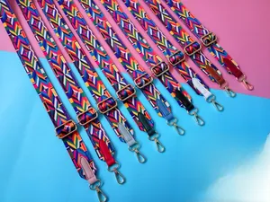 Close-up of colorful ethnic weaving bag straps with gold hardware and leather details