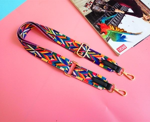 Close-up of colorful ethnic pattern woven bag strap with golden metal lobster clasps