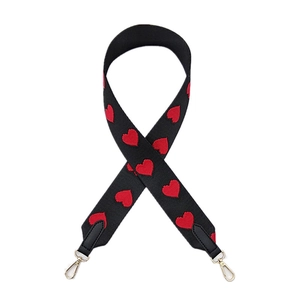 Wide black shoulder strap with red heart embroidery and golden metal swivel hooks