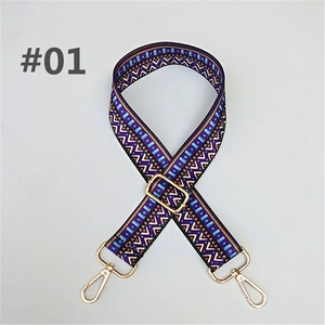 Close-up of geometric ethnic pattern woven bag strap with golden metal lobster clasps