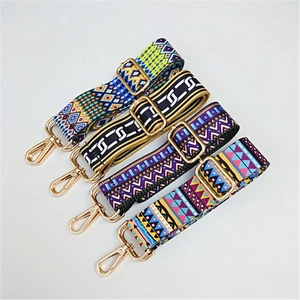 Detail of adjustable ethnic style bag straps with bohemian patterns and gold metal hooks