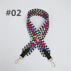 Detail of colorful geometric herringbone fabric strap with golden metal lobster clasps
