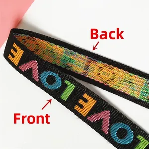 Detail showing front love embroidery and back multi-color weave of nylon shoulder strap