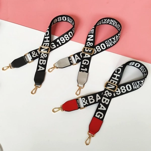 Close-up of colorful nylon wide shoulder straps with jacquard lettering and gold hooks