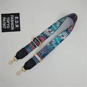 Detail of adjustable paisley strap showing ethnic patterns and golden metal buckles