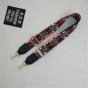 Adjustable wide jacquard bag strap with red geometric pattern and golden hardware