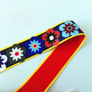 Close-up of floral nylon bag strap with colorful flower patterns and red back