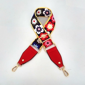 Detail of adjustable vintage floral bag strap with gold hardware and daisy pattern