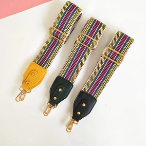 Close-up of colorful ethnic style woven bag straps with leather ends and gold metal hooks