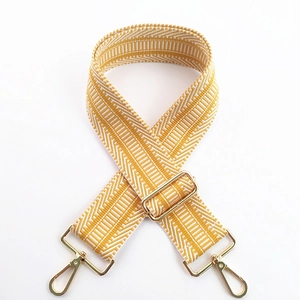 Close-up of mustard yellow geometric woven strap with premium gold metal lobster clasps