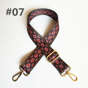 Close-up of ethnic geometric pattern webbing strap with golden metal buckles