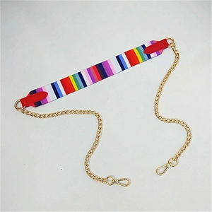 Detail of colorful rainbow woven shoulder strap with red leather ends and gold chain links