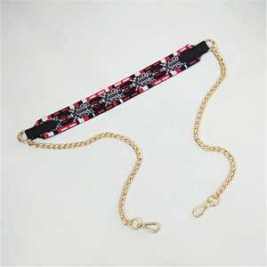Close-up of geometric jacquard shoulder strap with gold metal chain and leather detail