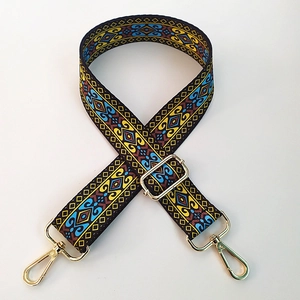 Close-up of ethnic geometric jacquard weaving strap with gold metal lobster clasp