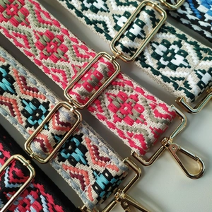 Detail of bohemian geometric embroidered bag straps with premium gold metal buckles
