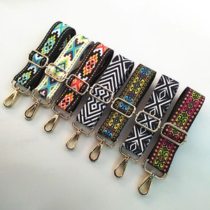 Detail view of seven ethnic pattern woven bag straps with gold metal hooks and buckles