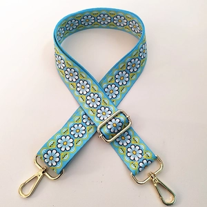 Detail of adjustable blue daisy strap with premium gold swivel lobster clasps
