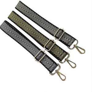 Three adjustable V-pattern woven bag straps with gold metal hooks on white background