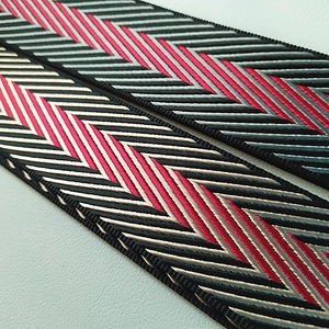 Adjustable nylon shoulder strap with herringbone pattern in black grey and magenta colors