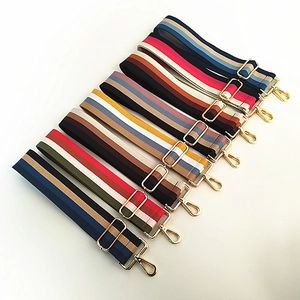Close-up of adjustable colorful striped cotton shoulder straps with gold metal hardware