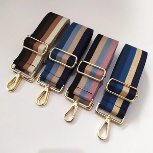 Detail showing four colorful striped cotton replacement straps with gold metal hardware