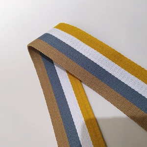 Detailed macro view of colorful striped cotton woven shoulder strap for handbags