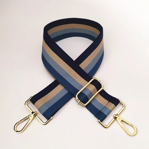 Close-up of adjustable striped woven strap with premium gold metal swivel hooks