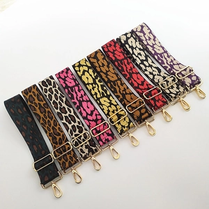Detailed view of adjustable leopard print bag straps with shiny gold hardware