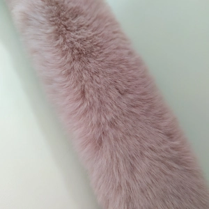 Macro shot of soft pink faux fur bag handle strap with plush texture and natural shine