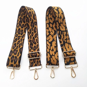 Detail of adjustable leopard print bag straps with golden lobster swivel clasps