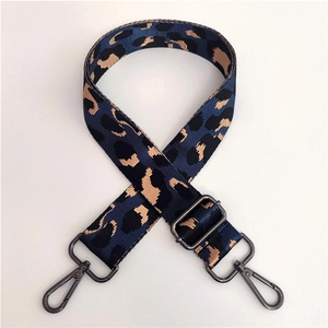 Detailed view of blue leopard nylon strap with gunmetal swivel hooks and buckle