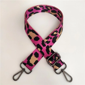 Detail of adjustable leopard print nylon shoulder strap with gunmetal swivel snap hooks