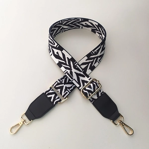 Detail of colorful ethnic geometric woven bag strap with golden metal lobster hooks