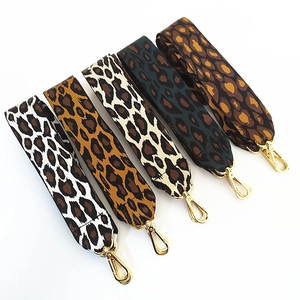 Detail view of five assorted leopard print nylon straps with gold lobster clasps