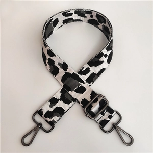 Detail of adjustable nylon leopard strap with dark grey metal hooks and thick webbing