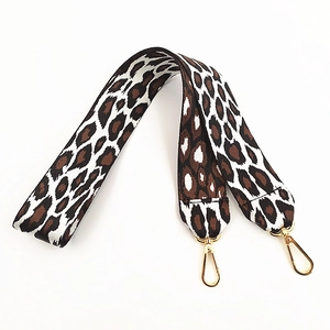 Macro view of leopard print nylon strap with high-quality golden metal lobster hooks
