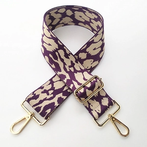 Detail of adjustable leopard print bag strap with vintage purple weaving and gold hooks