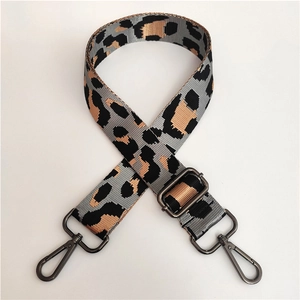 Detail of adjustable leopard print nylon shoulder strap with dark grey lobster clasps