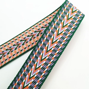 Close-up of geometric embroidered bag strap with purple and orange V-shaped patterns