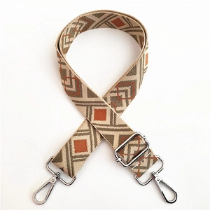 Close-up of ethnic geometric jacquard woven bag strap with silver metal swivel hooks