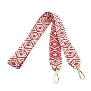 Ethnic style red and white woven bag strap with geometric patterns and gold clips